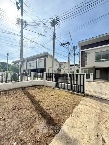 Modern residential neighborhood with contemporary houses and spacious driveways.