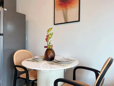 Charming dining nook with modern decor and elegant table setting in cozy apartment.