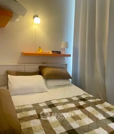 Cozy bedroom with modern lighting and stylish quilted bedding