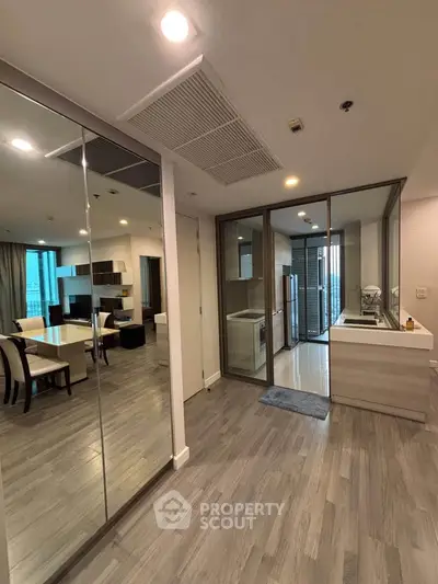 Modern open-plan living room with dining area and sleek kitchen design