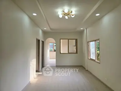 Spacious and bright living room with modern lighting and large windows