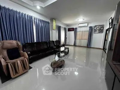 Spacious living room with modern furniture and large windows for natural light.