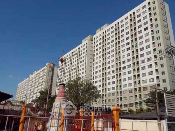 High-rise residential building with clear blue sky backdrop
