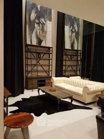 Luxurious living room with elegant decor and modern furniture, featuring a plush white sofa and artistic wall paintings.