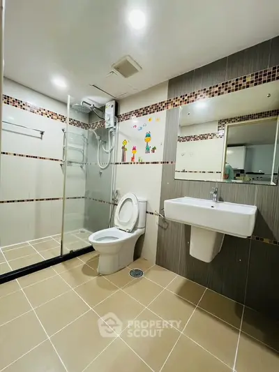 Modern bathroom with glass shower and stylish tile accents