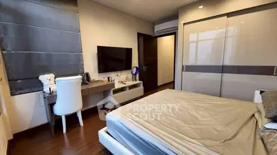 Modern bedroom with sleek furniture and large wardrobe, perfect for urban living.