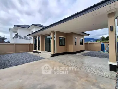 Modern single-story home with spacious driveway and sleek exterior design.