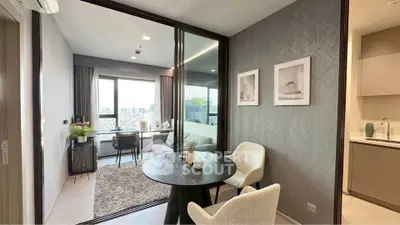 Modern apartment with open living and dining area, featuring city view and stylish decor.