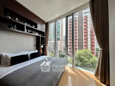 Luxurious bedroom with floor-to-ceiling windows offering stunning city views.