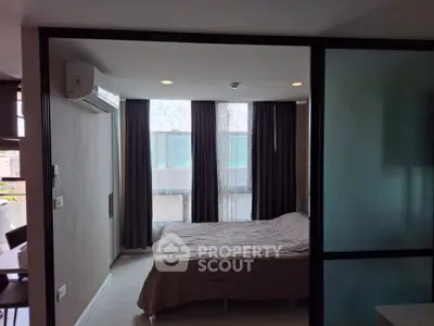 Modern bedroom with large windows and stylish curtains in a contemporary apartment.