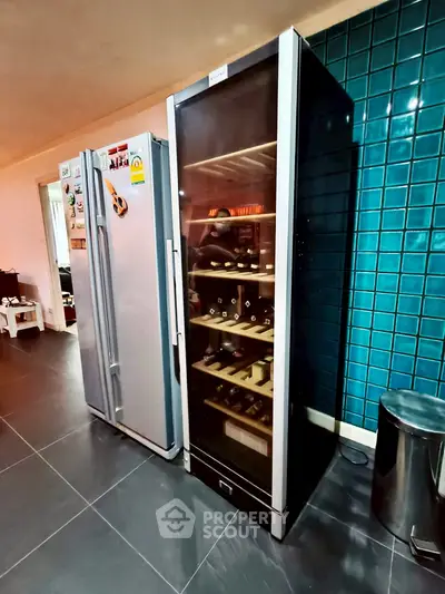 Modern kitchen with sleek wine fridge and stainless steel appliances