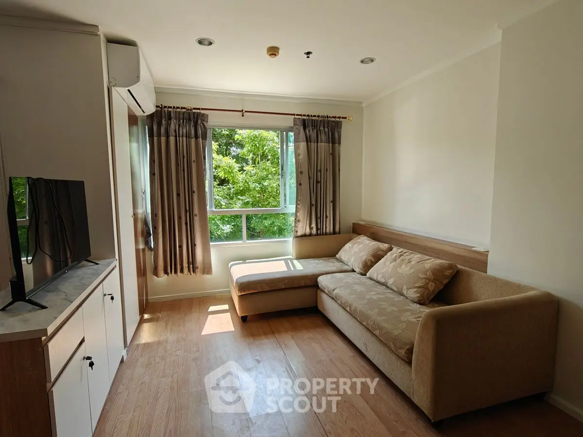 Bright living room with large window and cozy sectional sofa