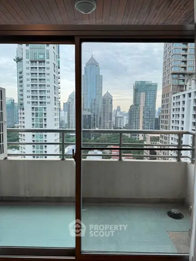 Spacious balcony with stunning city skyline view in high-rise apartment