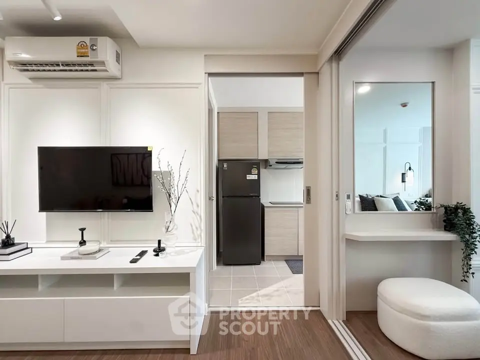 Modern living room with sleek TV setup and open kitchen view