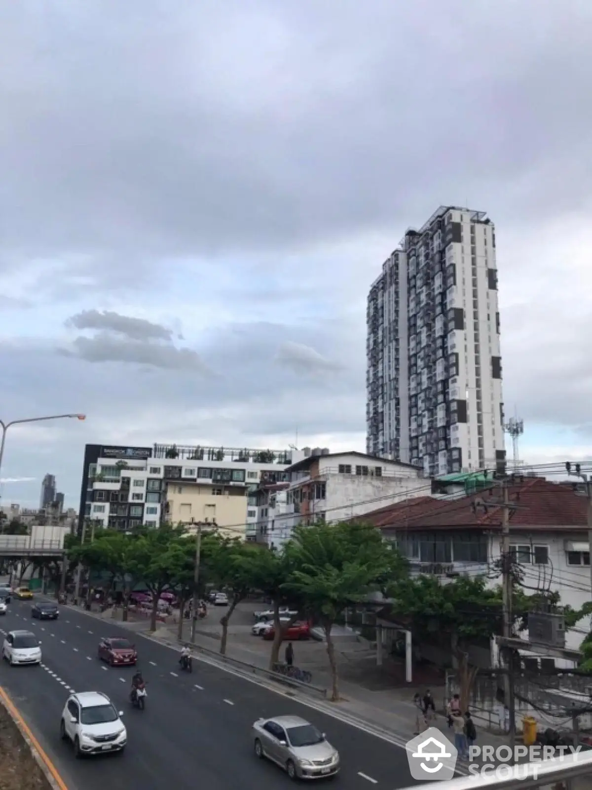 Urban cityscape with modern high-rise building and busy street view