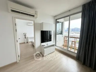Modern apartment with balcony and city view, featuring sleek interiors and ample natural light.