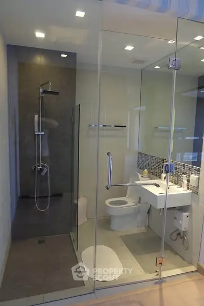 Modern bathroom with glass shower enclosure and sleek fixtures