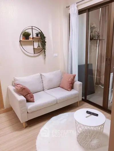 Cozy living room with modern decor and sliding glass doors to balcony