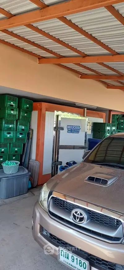 Spacious garage with ample storage and parking space, featuring organized shelving and a vehicle.
