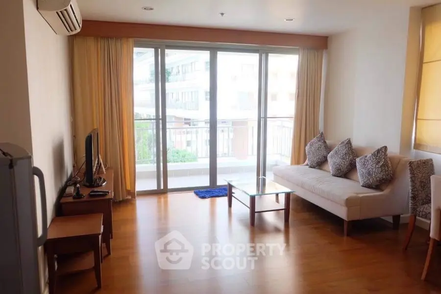 Spacious living room with balcony access and modern decor
