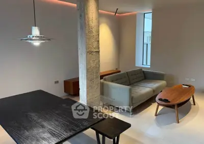 Modern living room with stylish furniture and exposed concrete column
