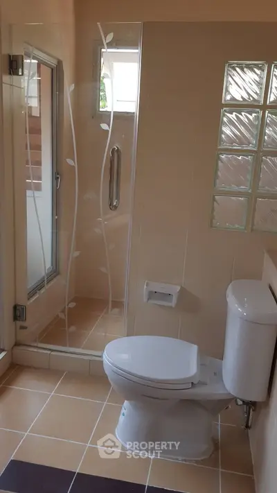 Modern bathroom with glass shower and elegant tile design