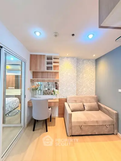 Modern living room with cozy sofa and stylish workspace in a bright apartment.