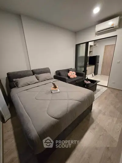 Modern bedroom with cozy bed and stylish decor in a contemporary apartment.