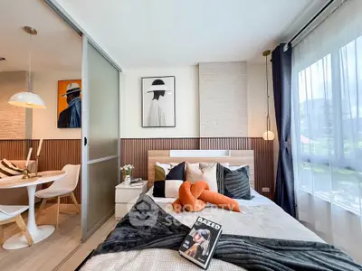 Modern bedroom with stylish decor and natural light, featuring a cozy bed and elegant dining area.