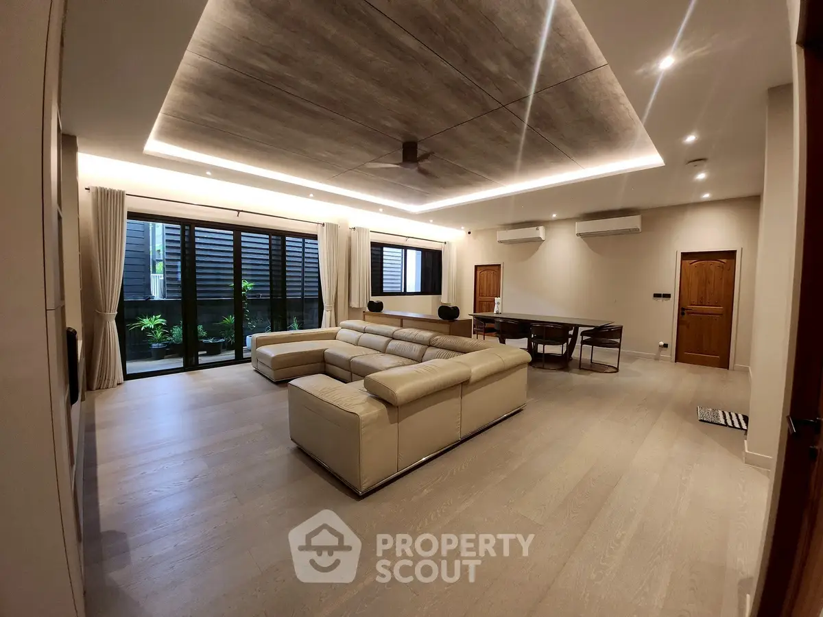 Spacious modern living room with elegant lighting and large windows