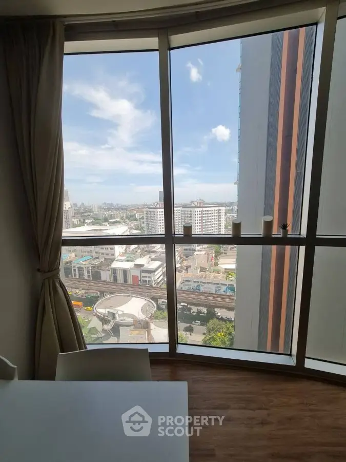 Stunning cityscape view from high-rise apartment window with modern decor