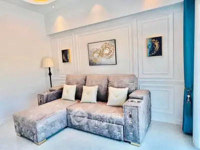 Luxurious living room with plush sectional sofa and elegant wall art, perfect for modern comfort and style.