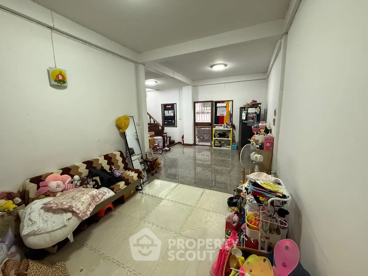 Spacious living room with cozy seating and ample storage space