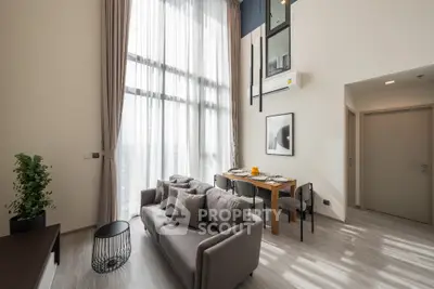 Modern living room with high ceilings and elegant dining area in a stylish apartment