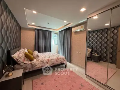 Spacious bedroom with modern decor and mirrored wardrobe