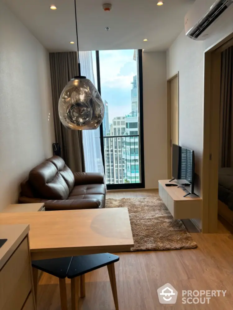 Modern living room with city view, stylish decor, and cozy seating area.