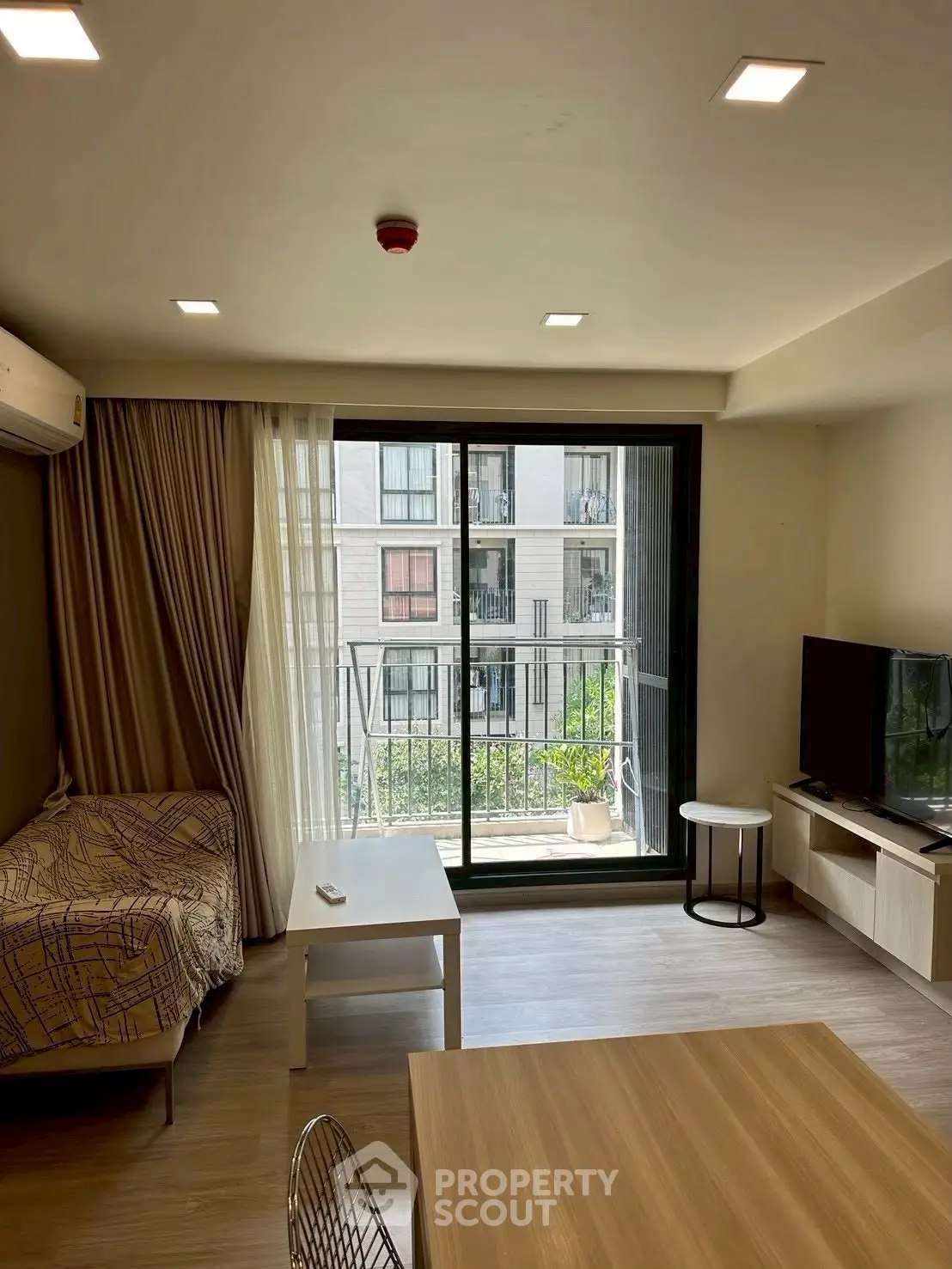 Modern living room with balcony view in urban apartment