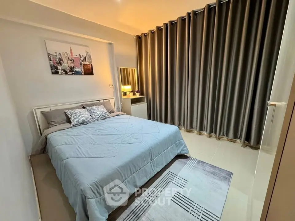 Cozy bedroom with modern decor and large window curtains, perfect for relaxation.
