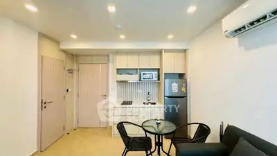 Modern open-layout kitchen with sleek appliances and cozy dining area in a stylish apartment.