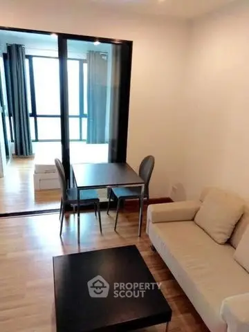 Modern living room with cozy sofa and dining area in open layout apartment