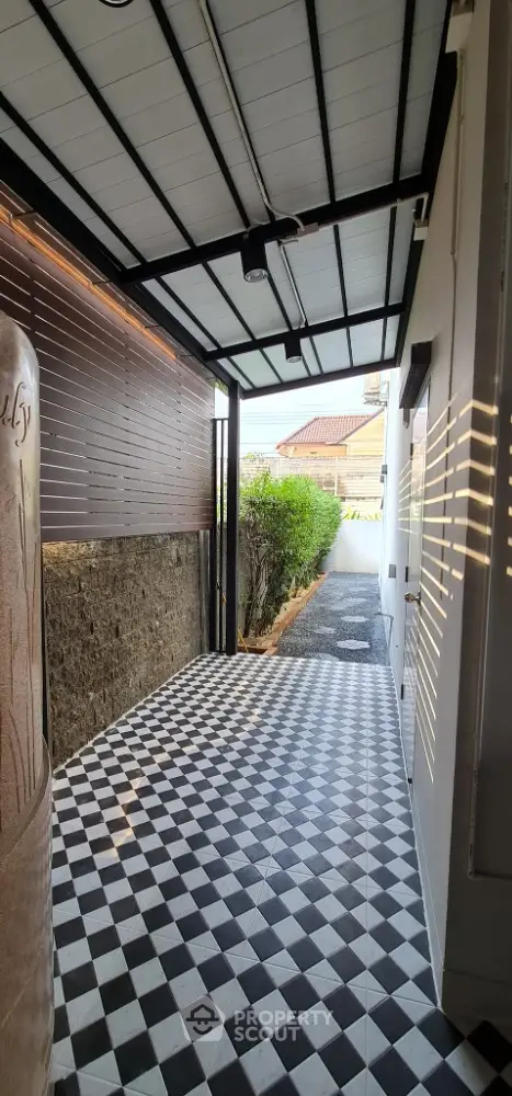 Charming covered entrance with checkered tiles and modern design