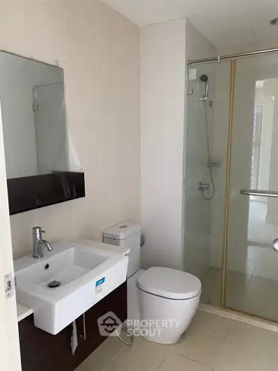 Modern bathroom with sleek fixtures and glass shower enclosure