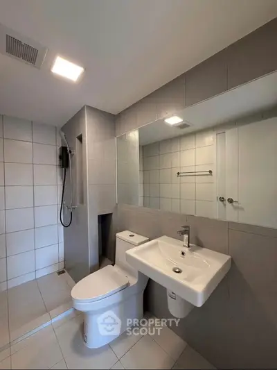 Modern bathroom with sleek fixtures and spacious shower area