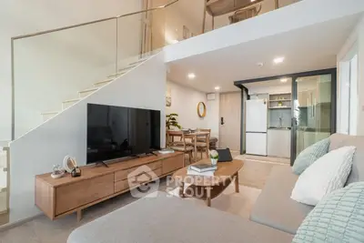 Modern living room with open kitchen and stylish decor in a duplex apartment