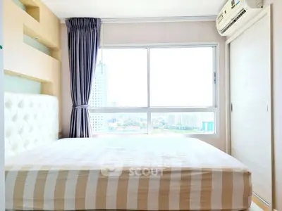 Bright bedroom with large window and city view, featuring a comfortable bed and air conditioning.
