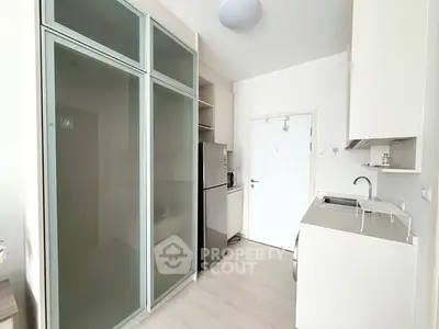 Modern compact kitchen with sleek cabinets and stainless steel appliances