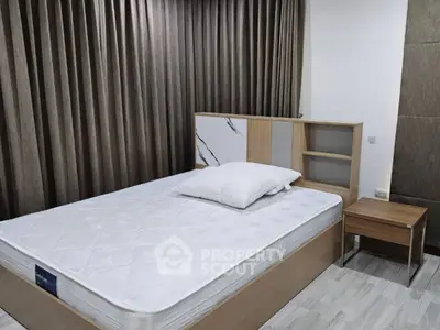 Modern bedroom with stylish headboard and elegant curtains, perfect for a cozy retreat.