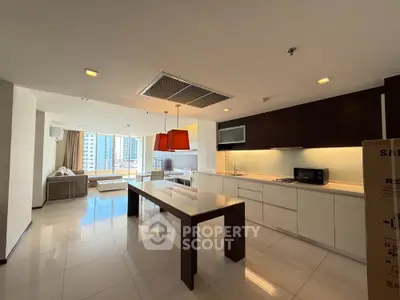 Spacious modern kitchen with open layout and city view, featuring sleek cabinetry and elegant lighting.