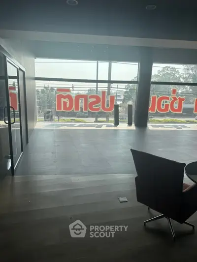 Spacious commercial space with large windows and modern flooring, ideal for retail or office use.