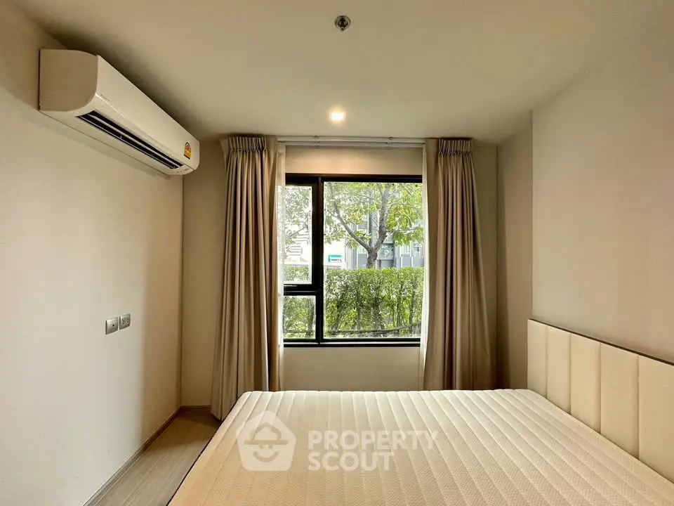 Modern bedroom with large window and air conditioning unit
